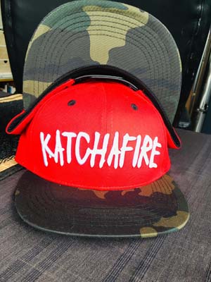The Katchafire X Calibis Snapback Cap is a custom designed cap, with a camo print on the peak.  White Katchafire logo on front.